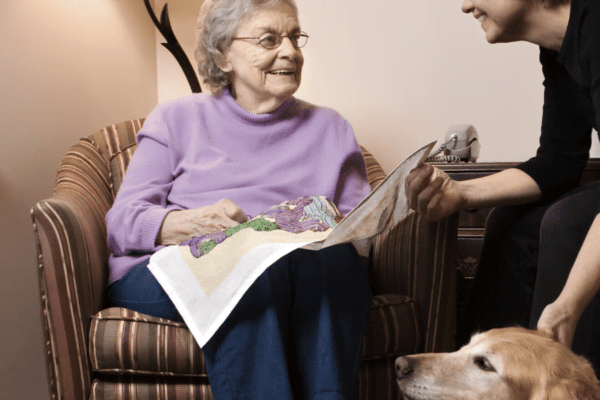 A care worker helping an elderly woman with dementia