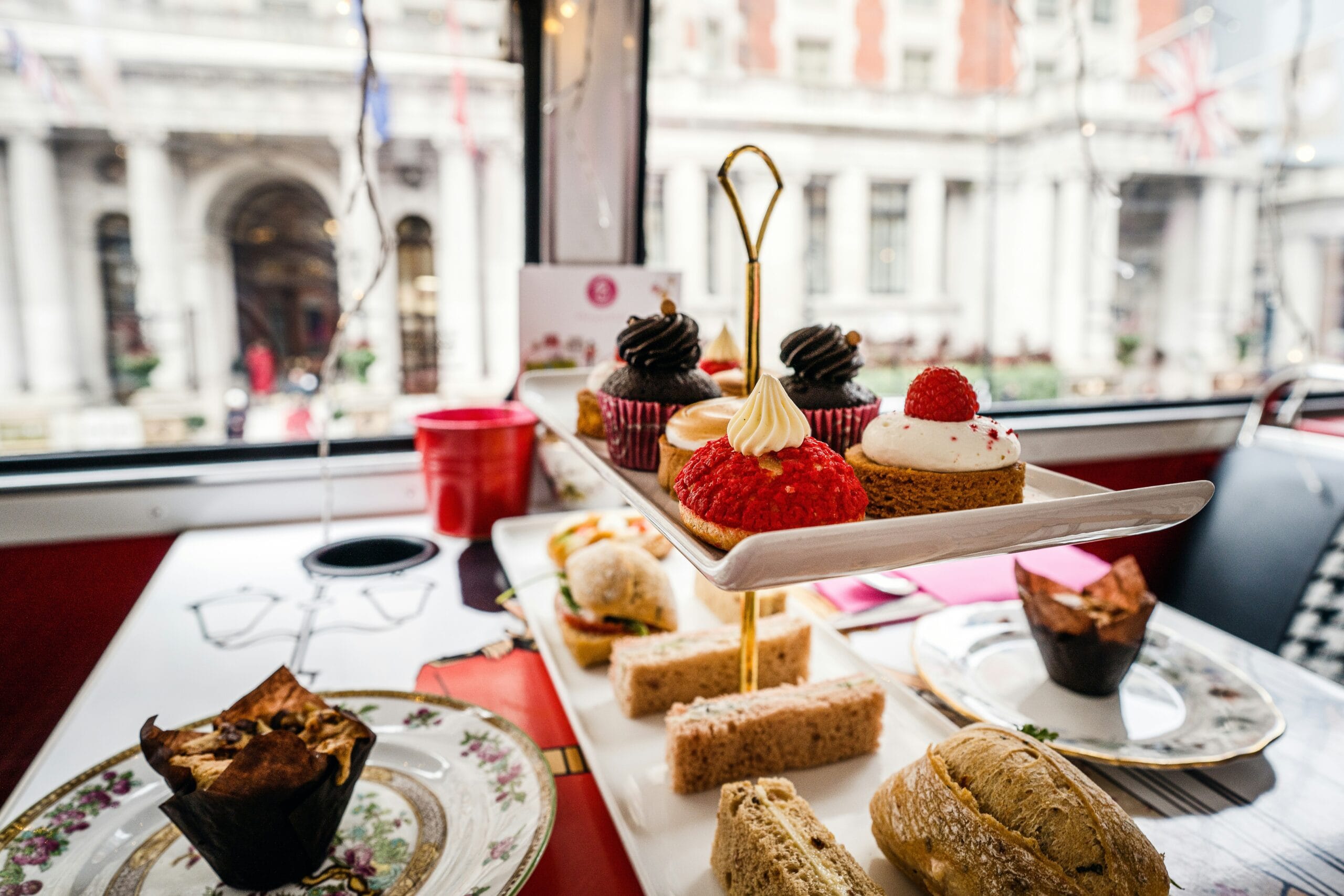 A display of small cakes, and finger sandwiches for an afternoon tea in London.