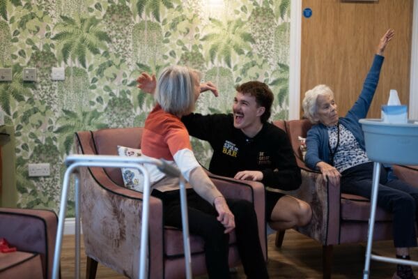 Bailey Greetham-Clarke pictured in a care home delivering an exercise class with elderly people