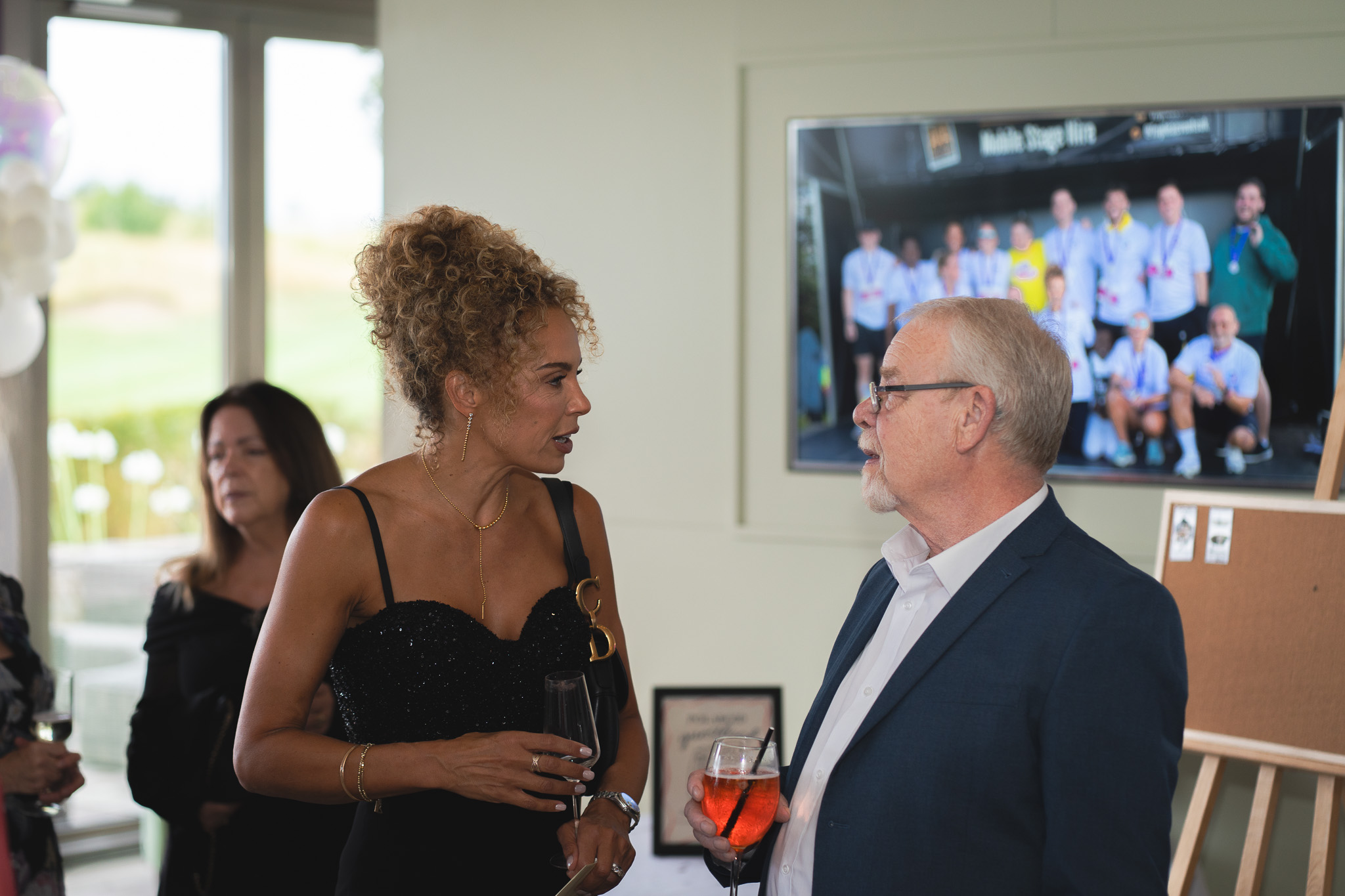 Abbots Care CEO Camille Leavold pictured in discussion at Abbots Care's 30th Birthday celebration