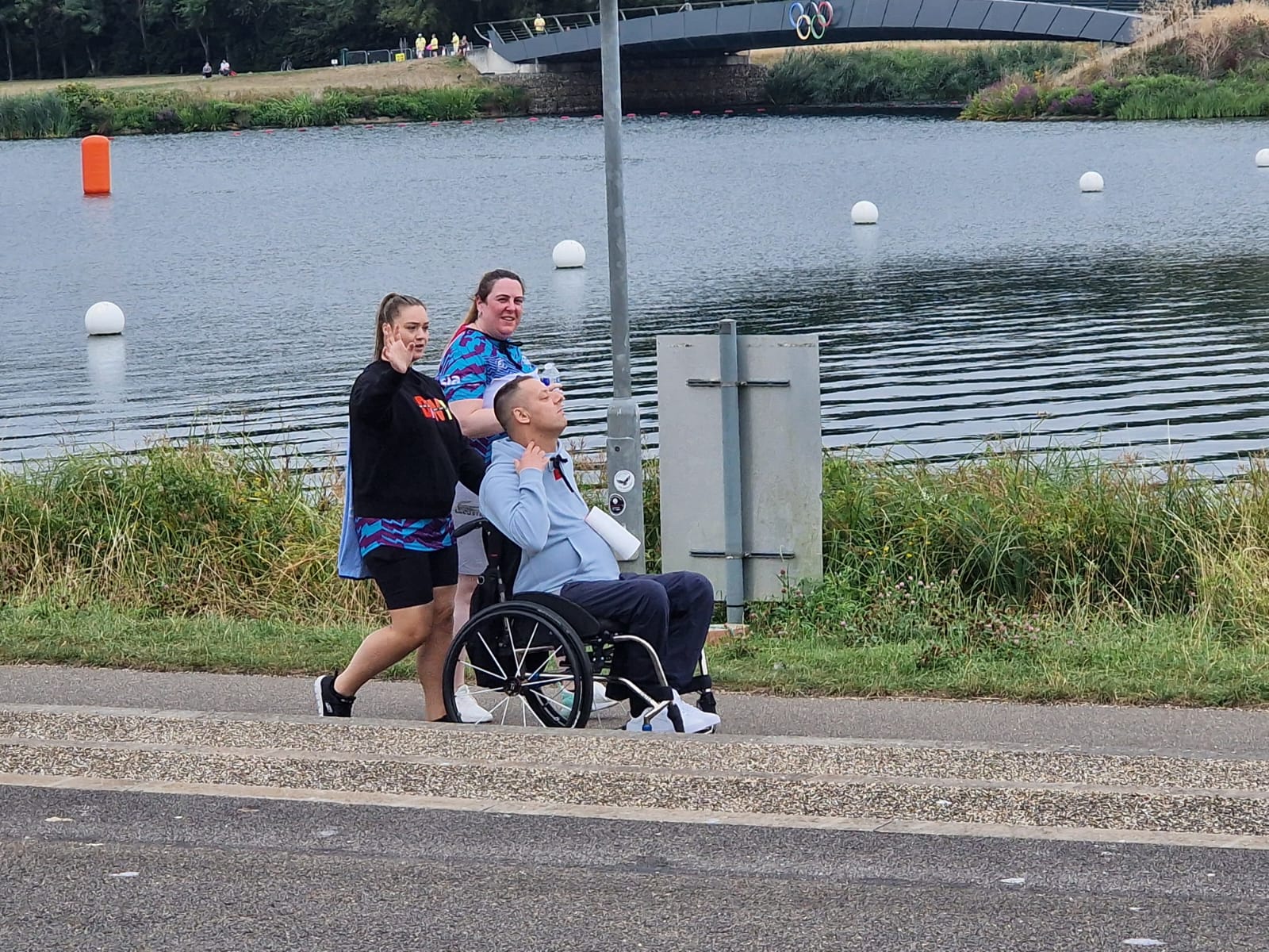 Abbots Care team member Jazz running and pushing client Steve in a wheelchair during the Superhero Triathlon.