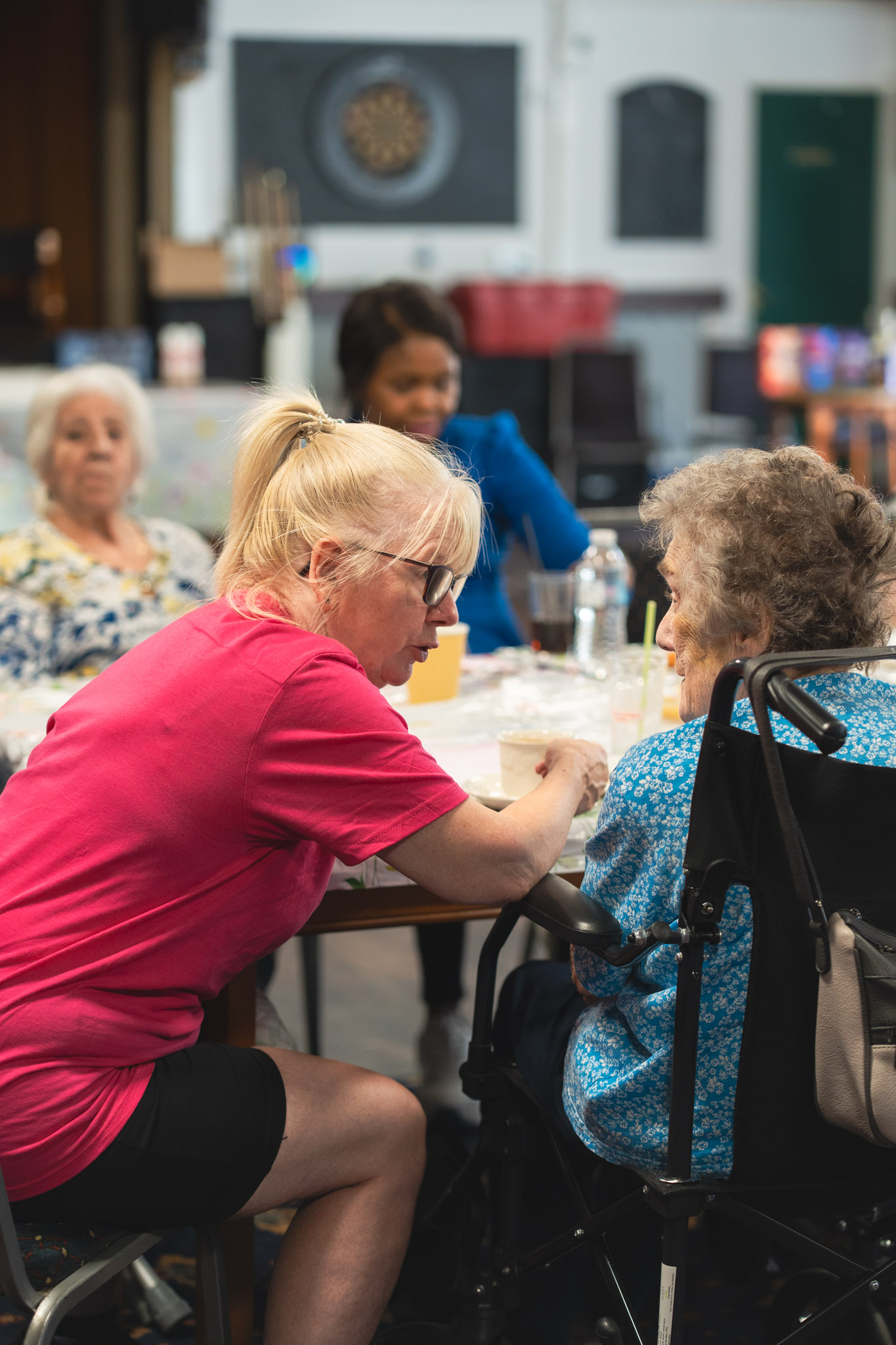 Care Worker Tina interacts with a client at a tea party
